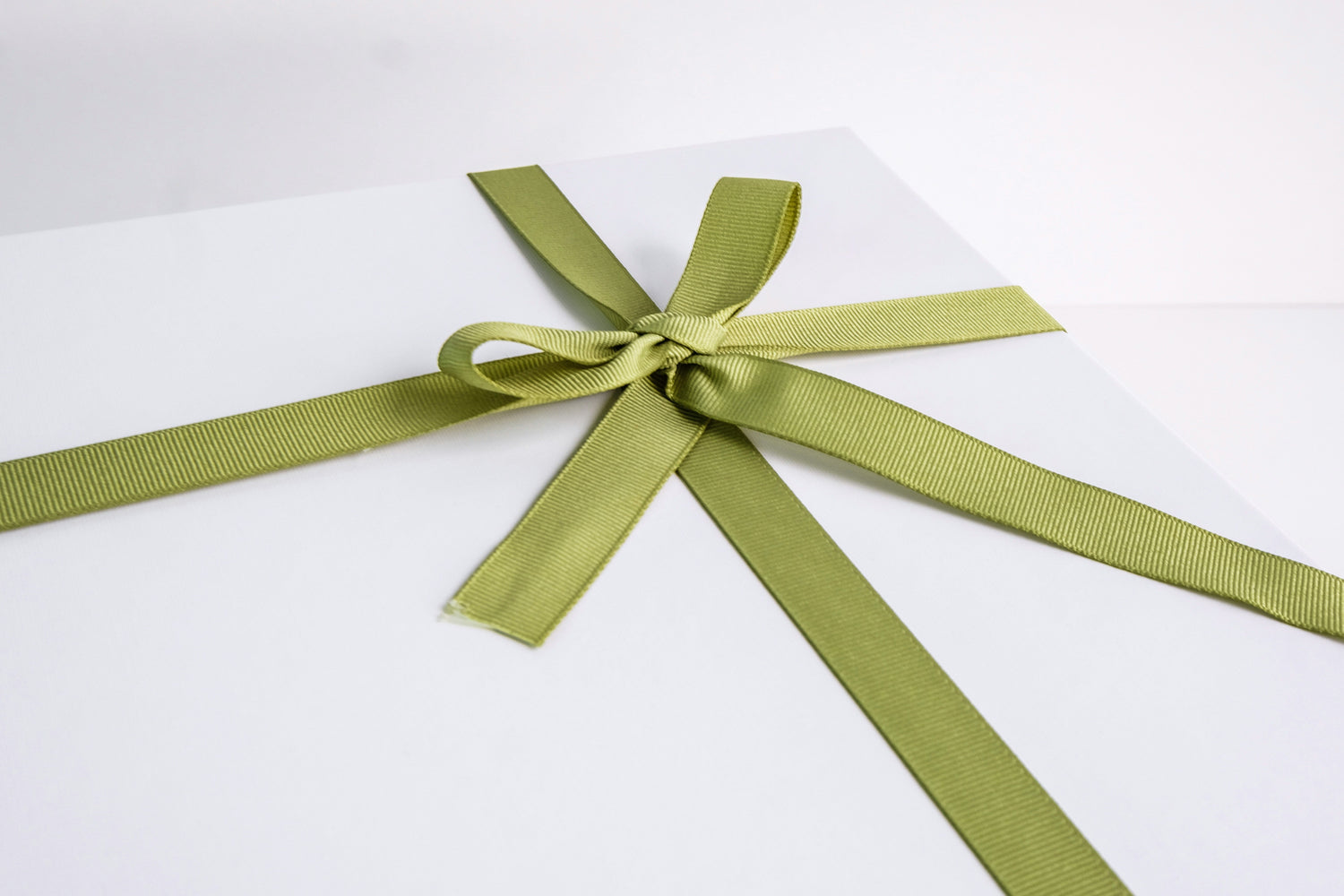 Photo by Raelle Cameron on Unsplash of a large painting wrapped up as an art gift
