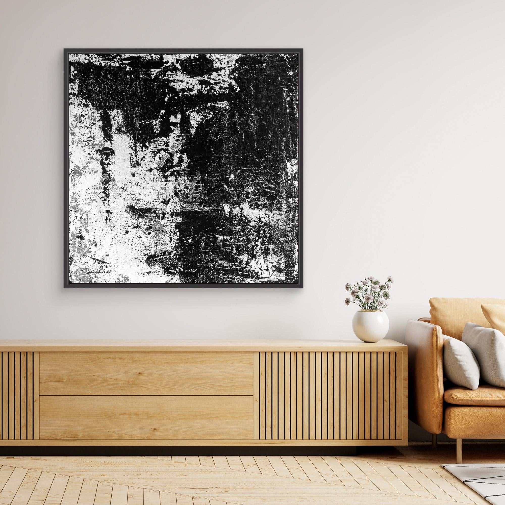 Abstract black and white painting on a wall above a wooden sideboard in a living room.
