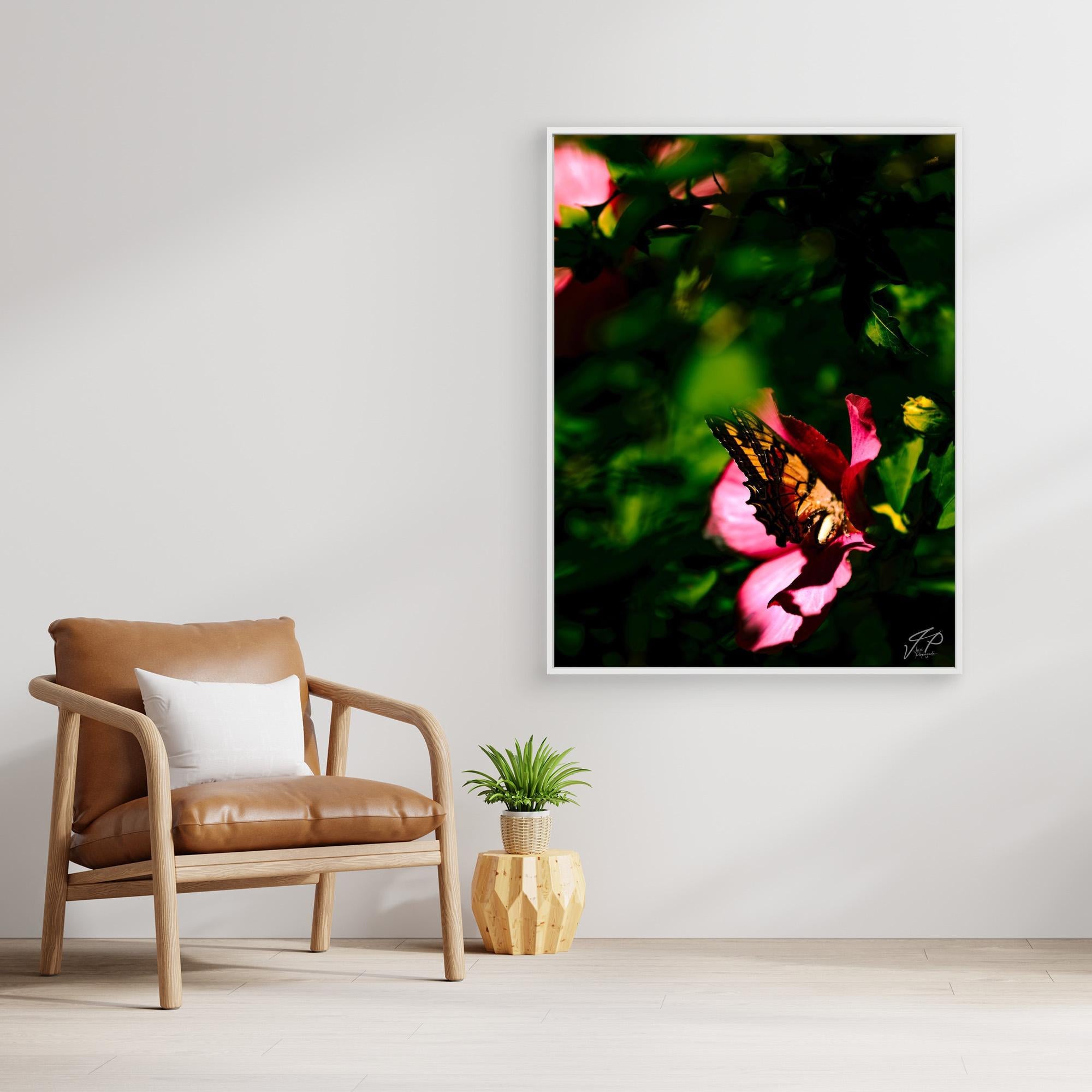 Minimal living space with a tan chair, white pillow, small plant, and wall art of a butterfly on a flower.