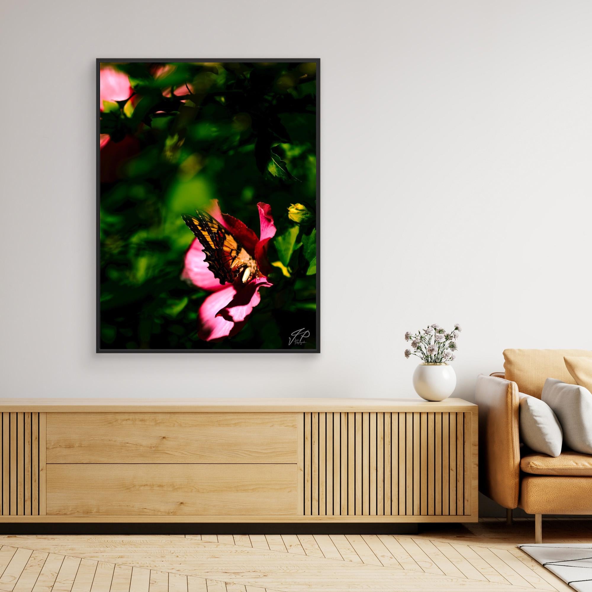 A modern living space with a wooden console, tan sofa, and wall art of a butterfly on a flower.