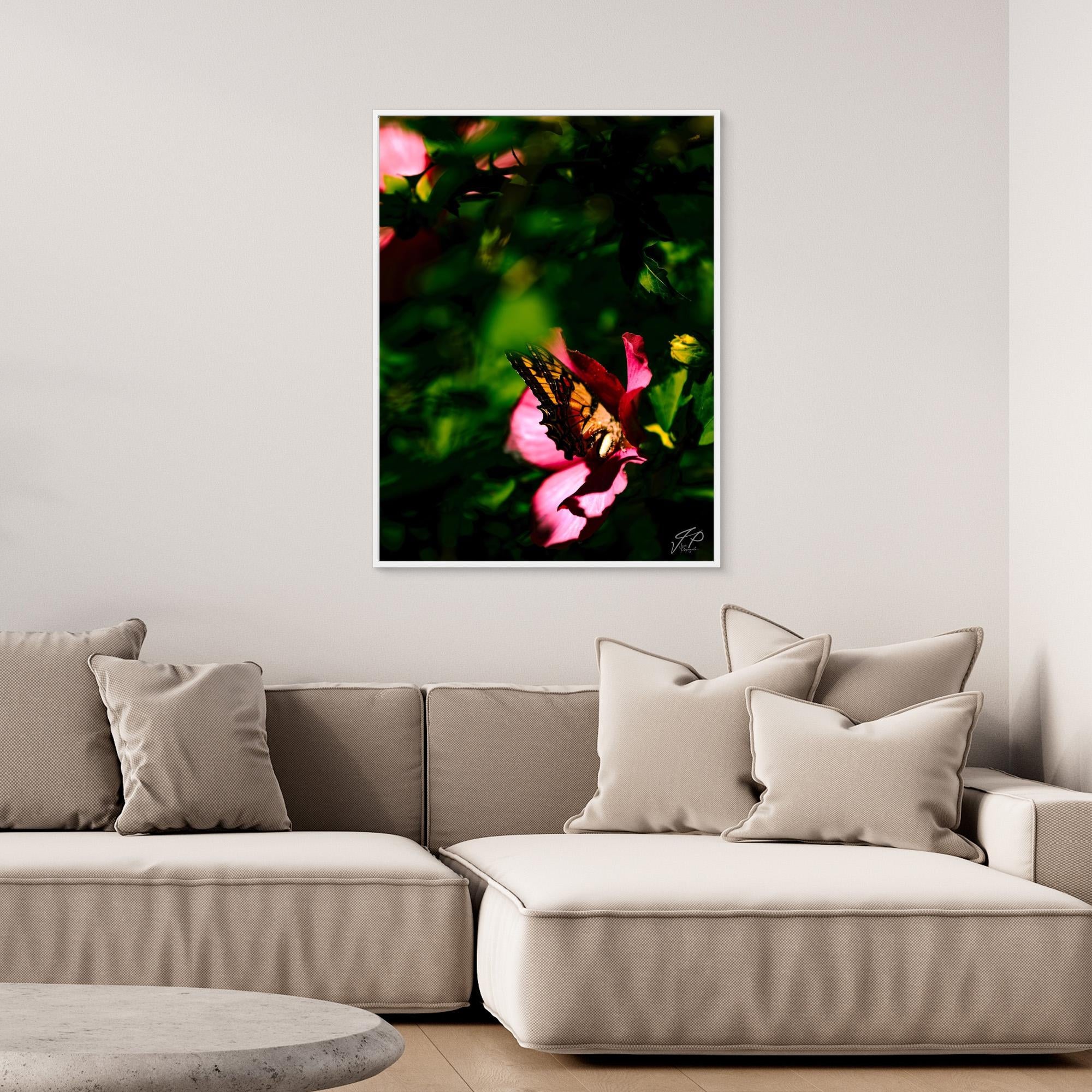A cozy living room with a beige sectional sofa and a nature-themed wall art of a butterfly on a pink flower.