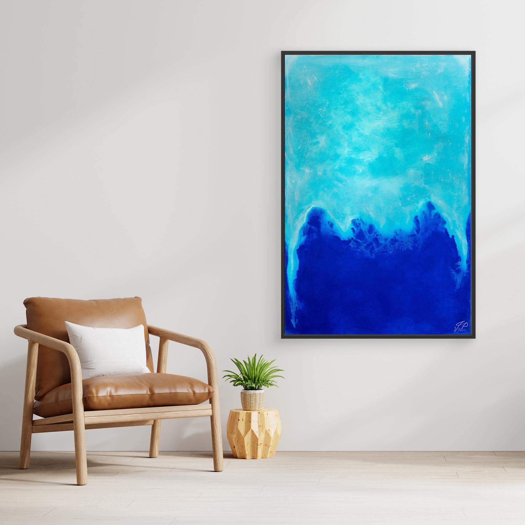 A modern living space features a tan chair, small plant, and large abstract blue artwork on wall.