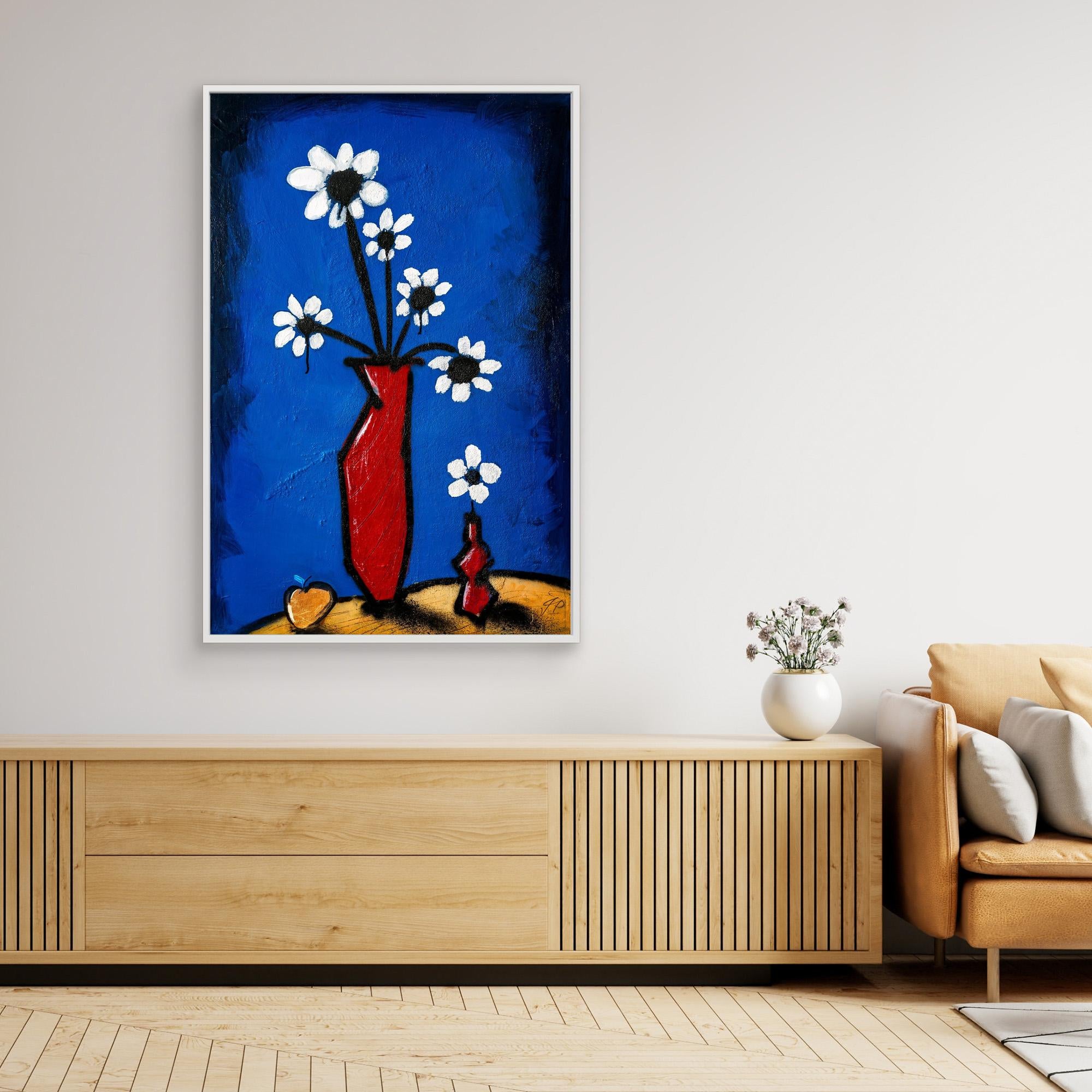 Abstract painting of white flowers in red vase, above wooden console, beige sofa, and white vase.