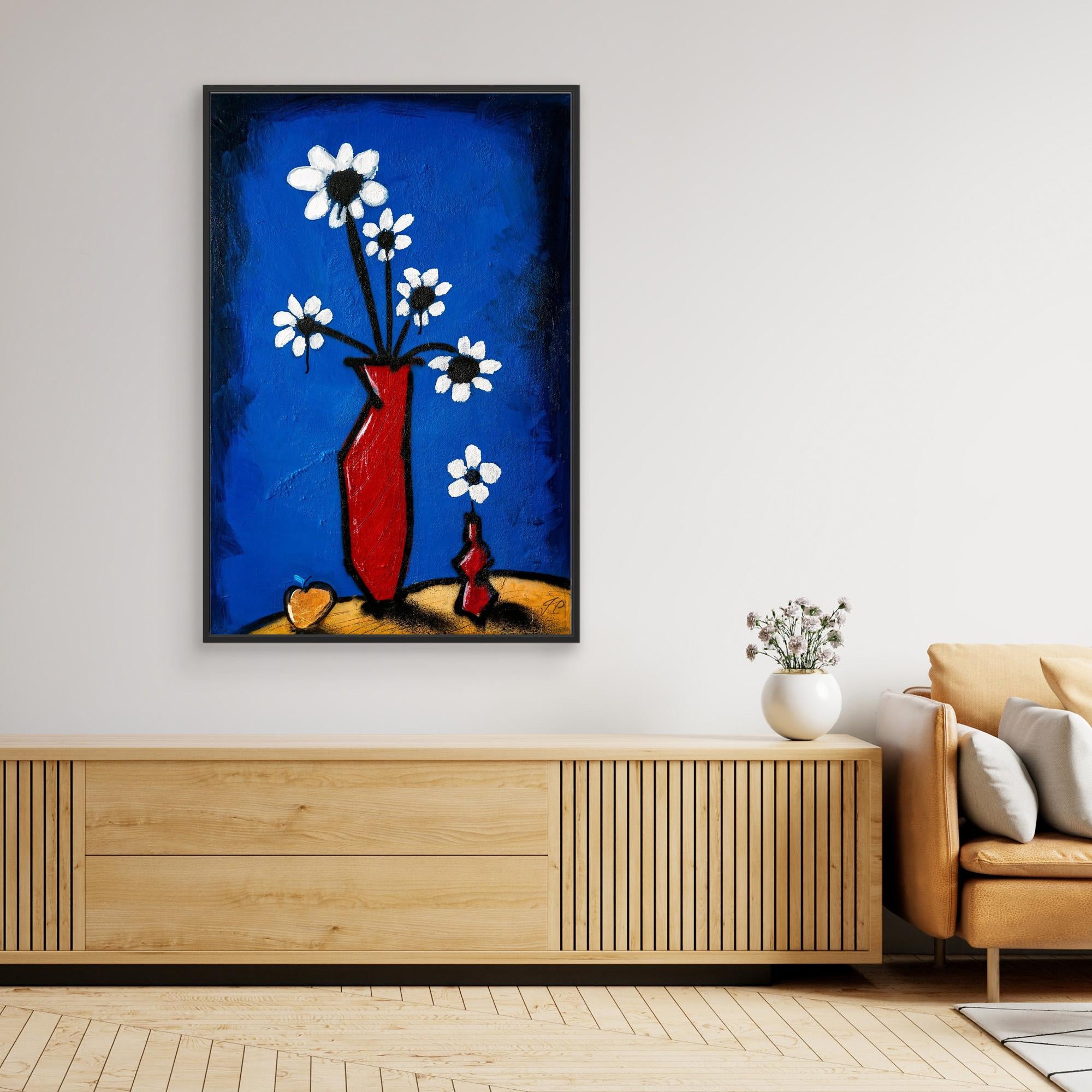 Abstract painting of white flowers in red vase, above wooden console, beige sofa, and white vase.