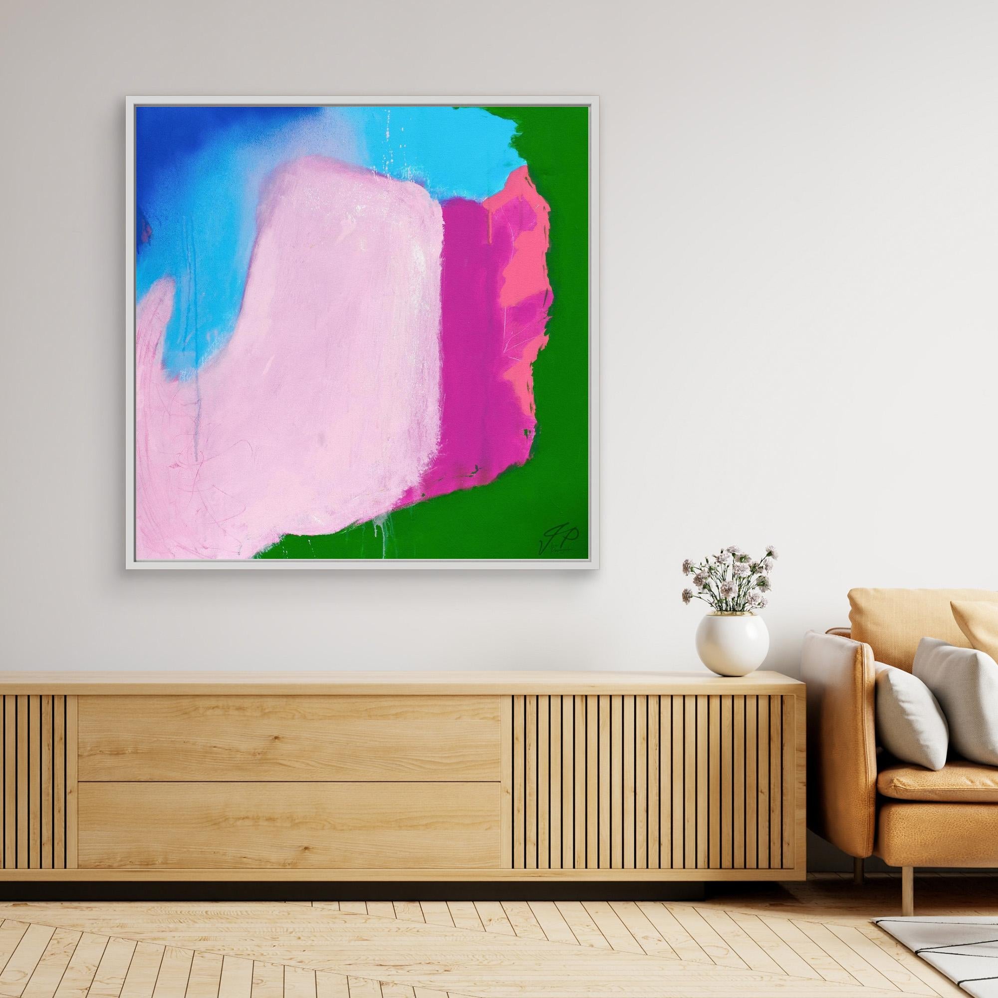 Abstract painting with pink, blue, green, and magenta shapes above wooden console table and beige sofa.