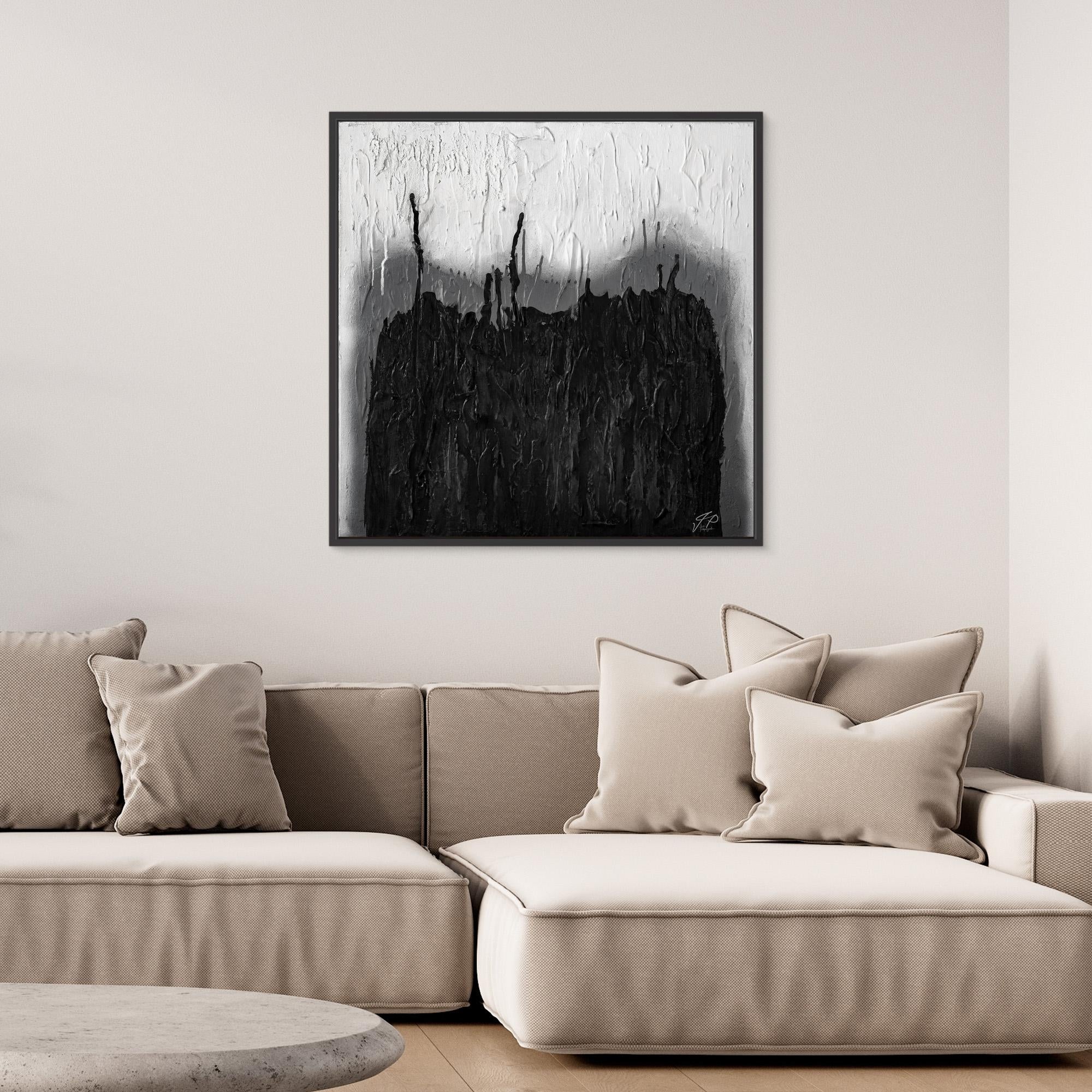 Black and white abstract textured painting hangs above a beige sectional sofa with soft pillows in a modern living room.