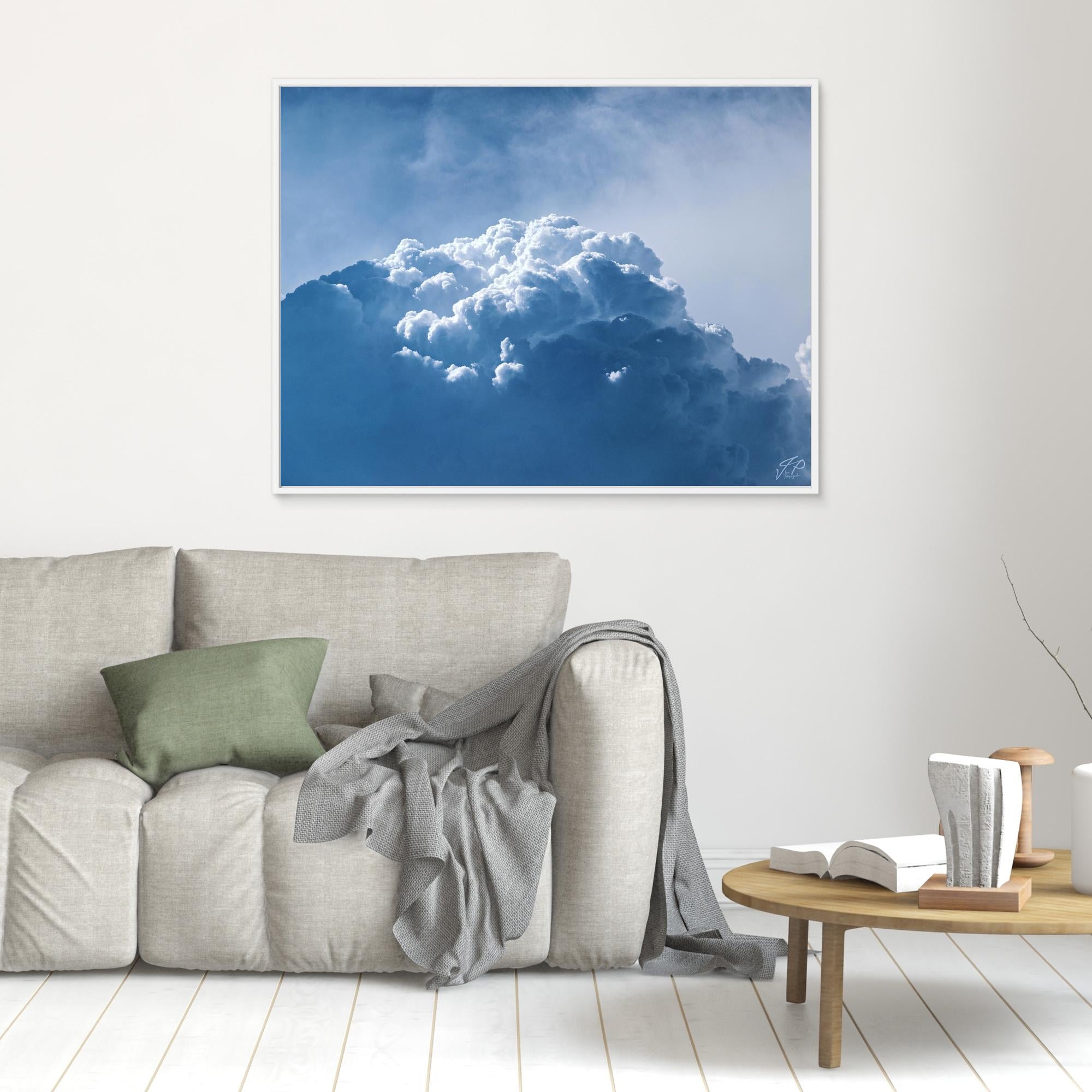 Framed photograph of a cloud above a sofa in a living room