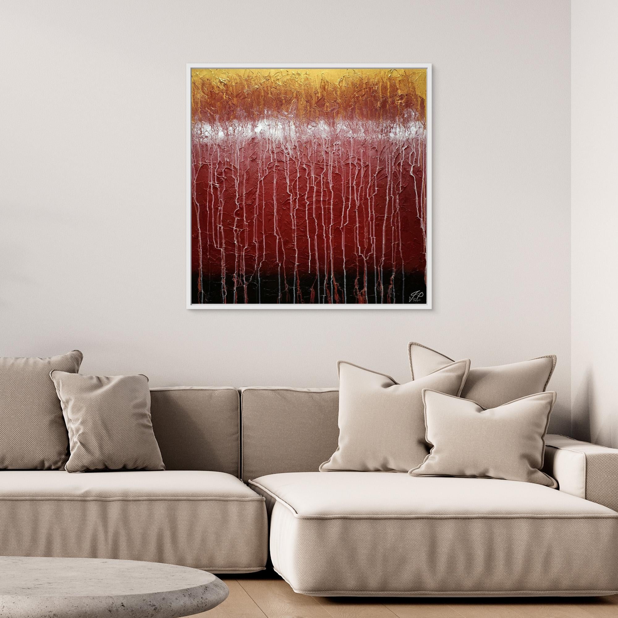 Textured abstract art with gold, white, and red colors above a beige sectional sofa with neutral pillows.