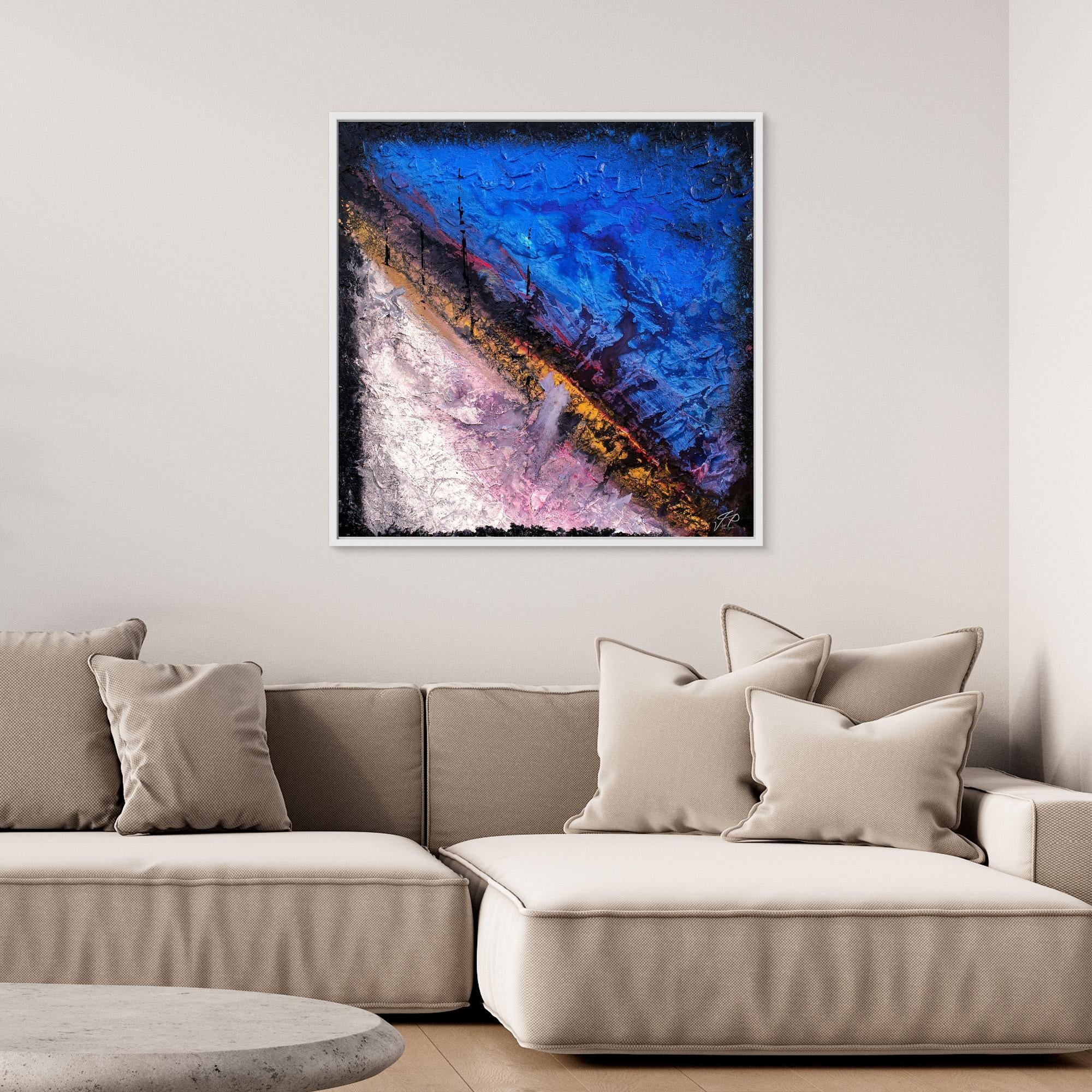 Abstract painting with blue, pink, yellow diagonal colors hangs above a beige sectional sofa with cushions.