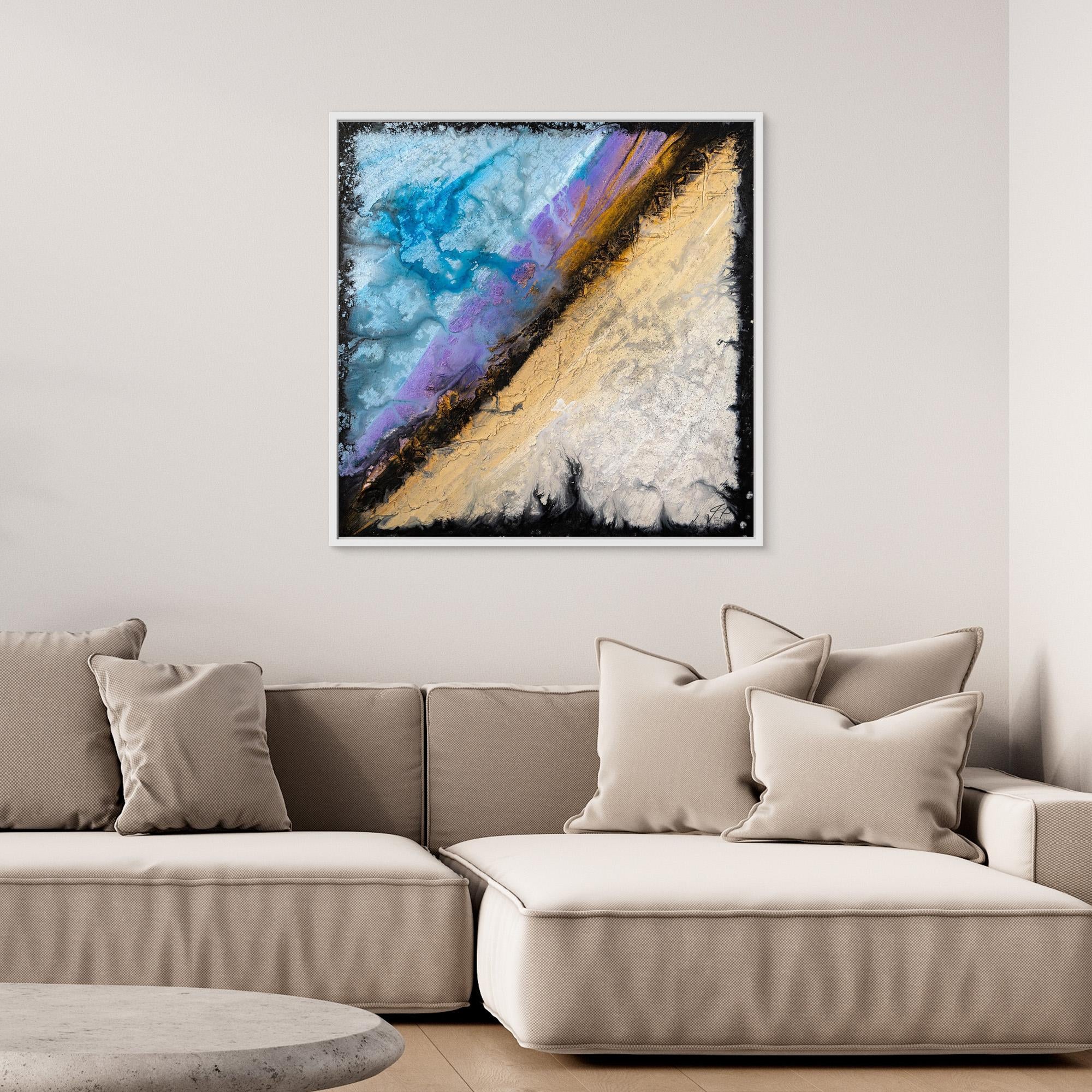 Abstract painting with blue, purple, beige, and gold hues hangs above a beige sectional sofa with pillows.