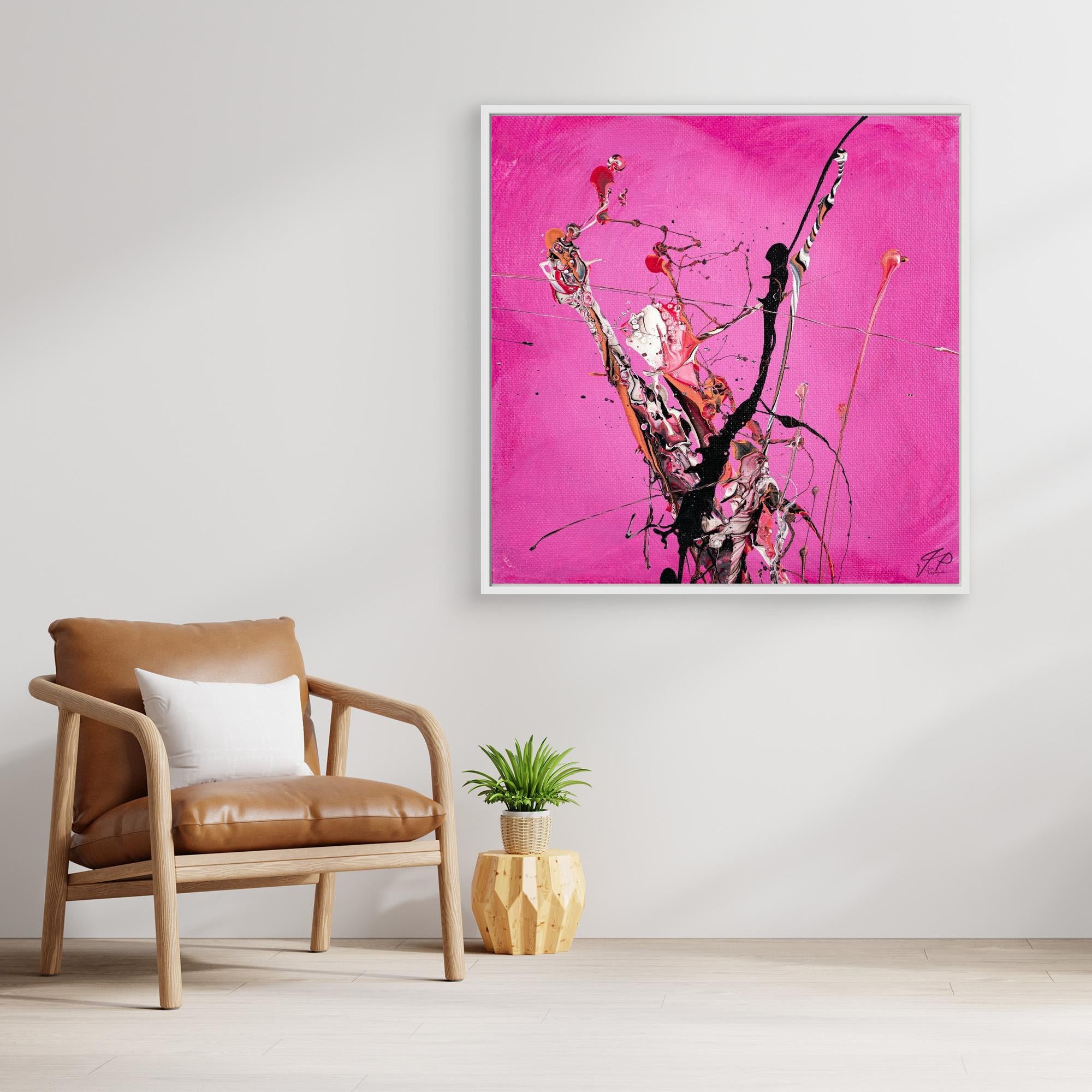 Abstract art with black, white, and pink splashes on a bright pink background beside a wooden leather chair.