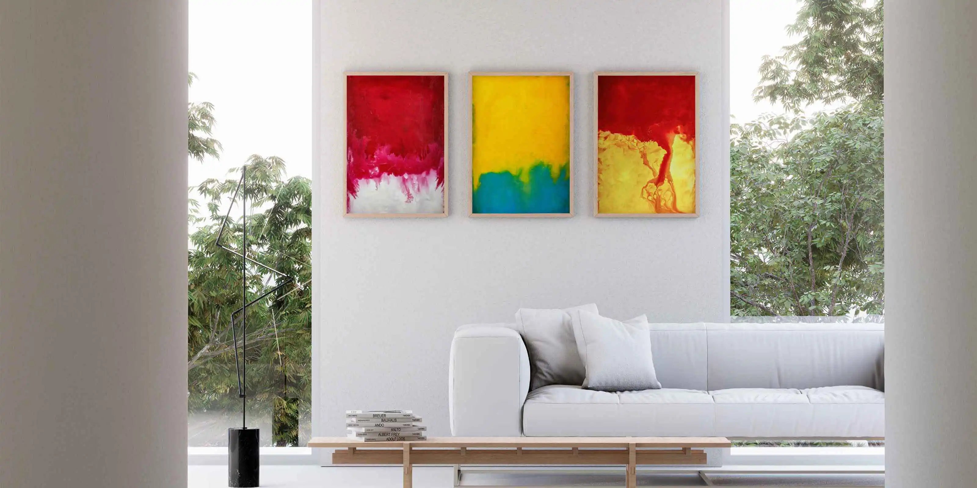 New modern living room with a white sofa and colorful abstract paintings and art prints on the wall.