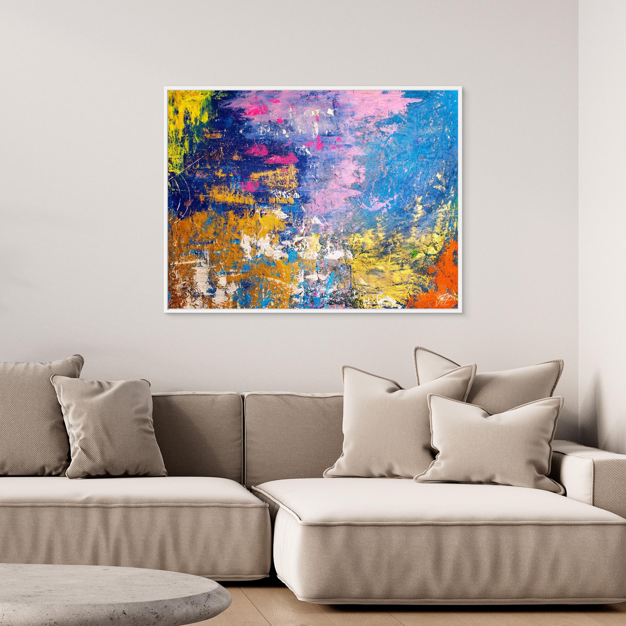 Modern living room with beige sectional sofa, neutral cushions, and bright abstract painting featuring blue, yellow, and pink.