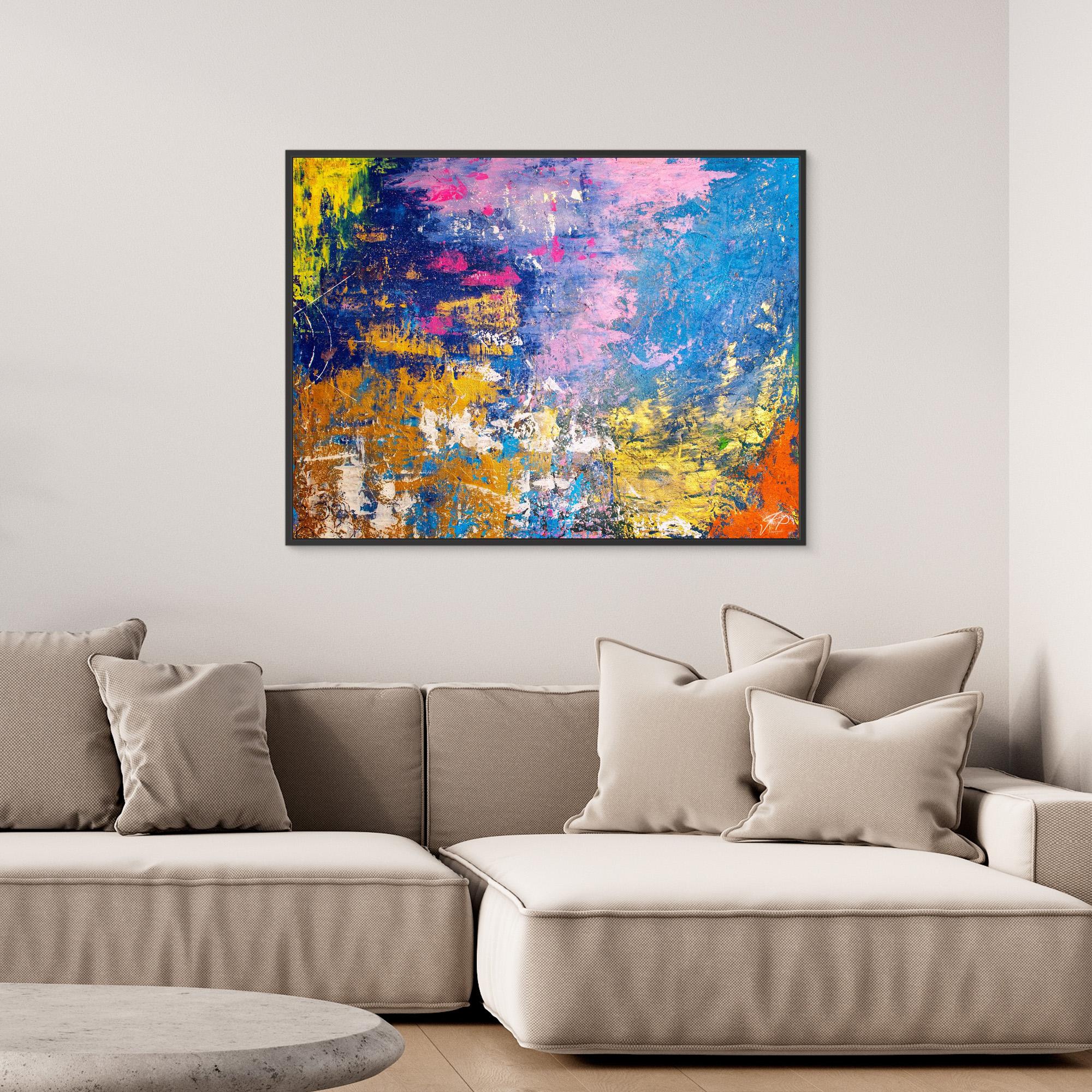 Modern living room with beige sectional sofa, neutral cushions, and bright abstract painting featuring blue, yellow, and pink.