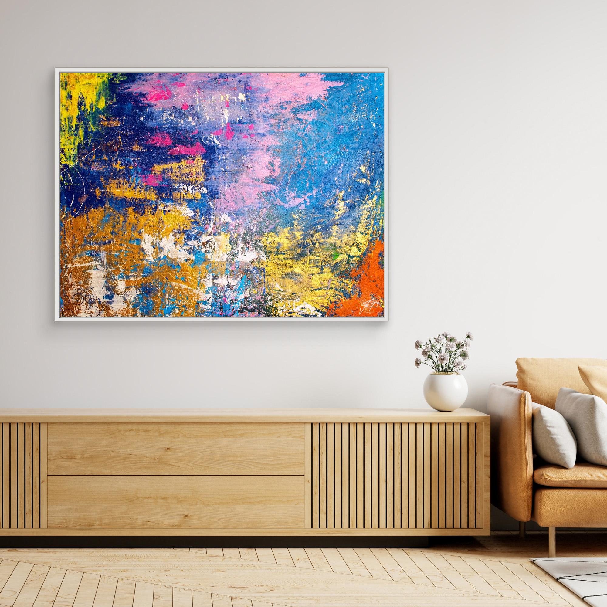 Large colorful abstract painting with blue, pink, yellow, and orange displayed above a modern wooden sideboard.