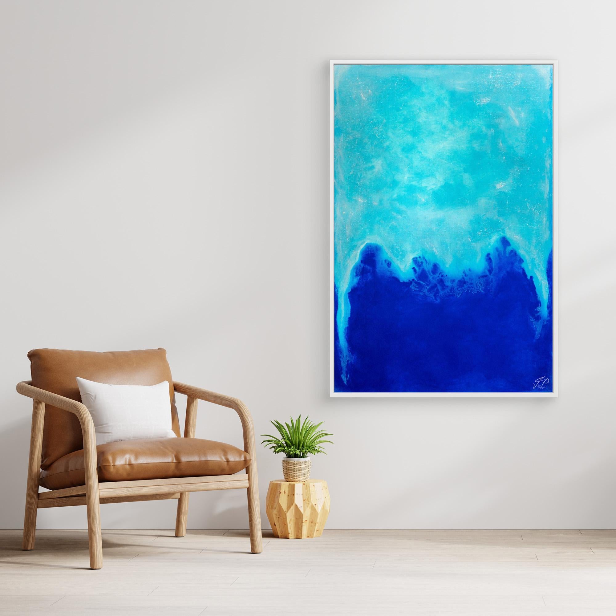 A modern living space features a tan chair, small plant, and large abstract blue artwork on wall.