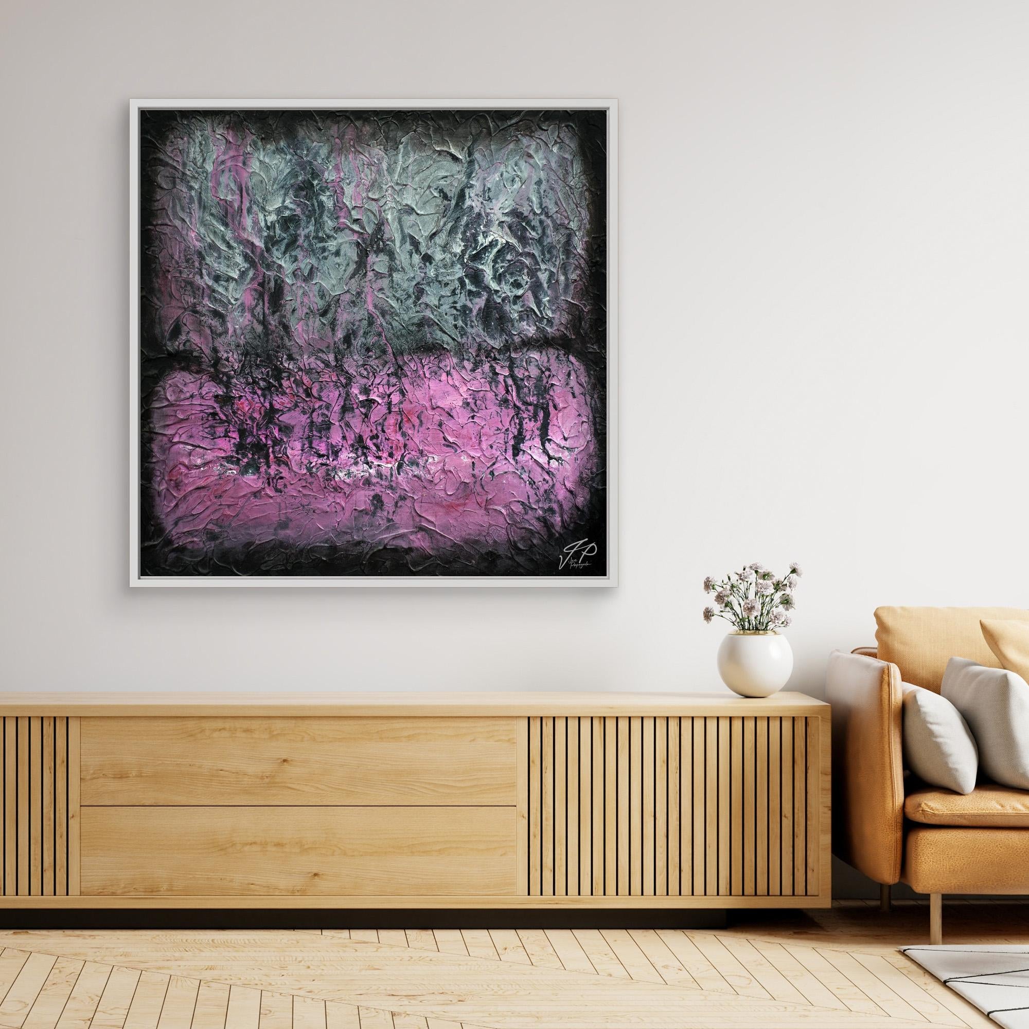 Textured abstract painting with black, gray, and pink colors in a white frame above a wooden console.