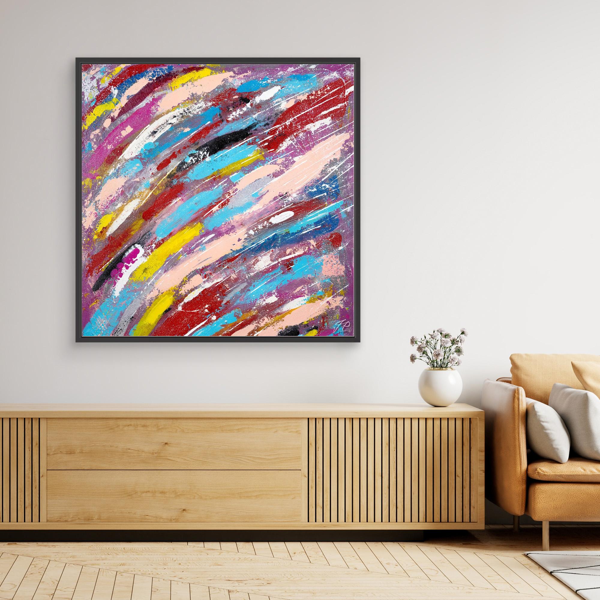 A canvas print of an abstract multicolor painting displayed on a wall.